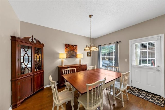 10535 Willow Meadow Cir, Alpharetta, GA 30022 - dining space featuring dark wood finished floors, a chandelier, and a textured ceiling