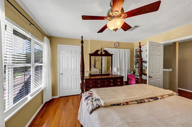 10535 Willow Meadow Cir, Alpharetta, GA 30022 - bedroom with a textured ceiling, wood finished floors, and a ceiling fan