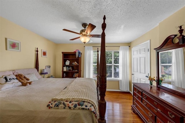 10535 Willow Meadow Cir, Alpharetta, GA 30022 - bedroom with wood finished floors, a textured ceiling, and ceiling fan