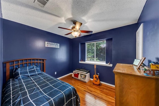 10535 Willow Meadow Cir, Alpharetta, GA 30022 - bedroom featuring wood finished floors, a textured ceiling, and a ceiling fan