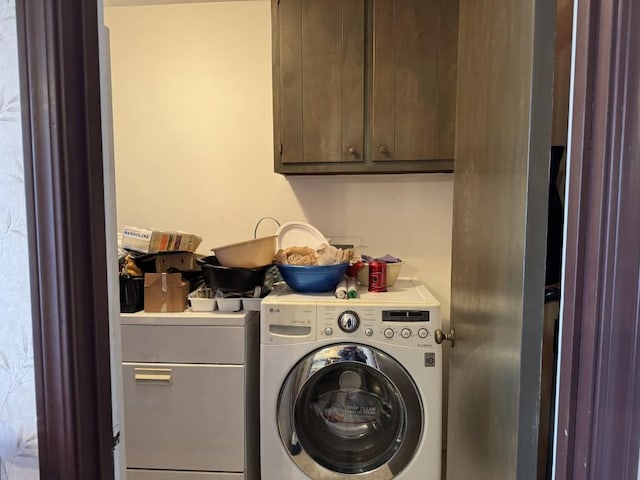 laundry room featuring cabinets and separate washer and dryer