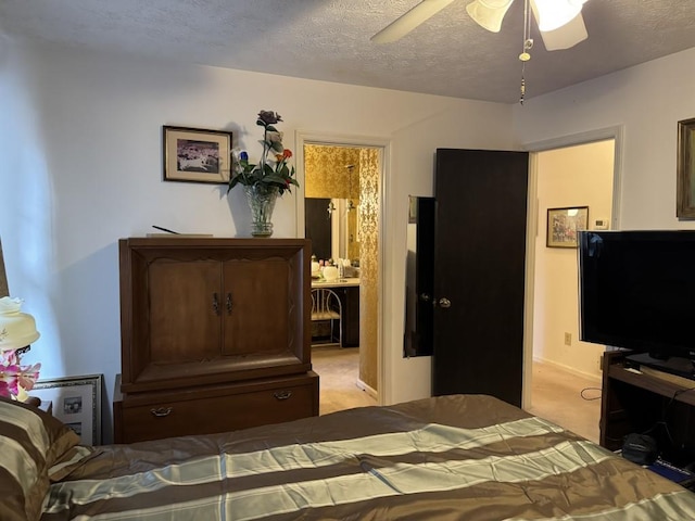 carpeted bedroom featuring a textured ceiling, ceiling fan, and ensuite bathroom