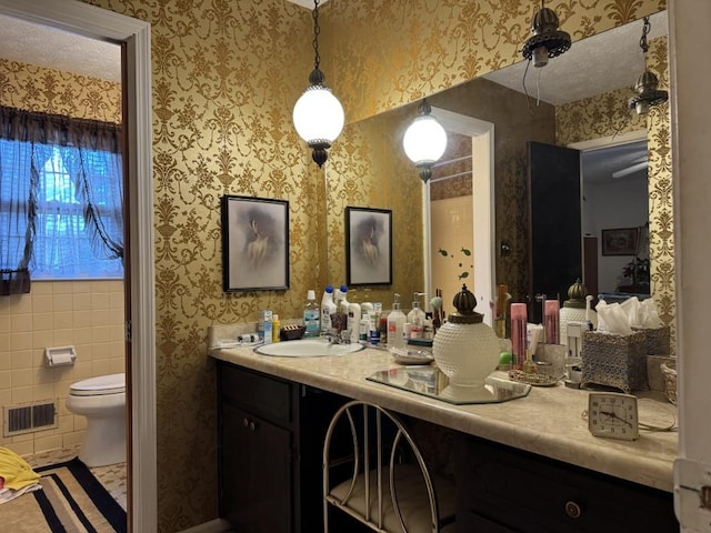 bathroom featuring toilet and vanity