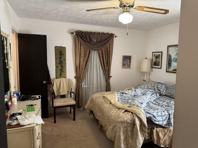 carpeted bedroom featuring ceiling fan and a textured ceiling