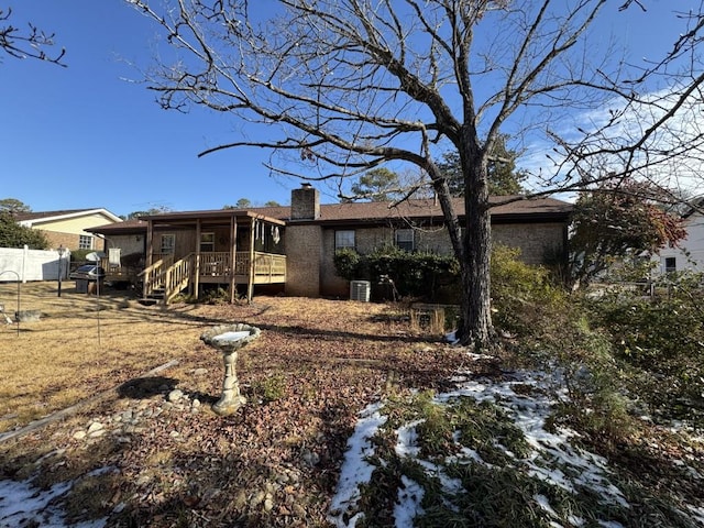 snow covered house with central AC unit