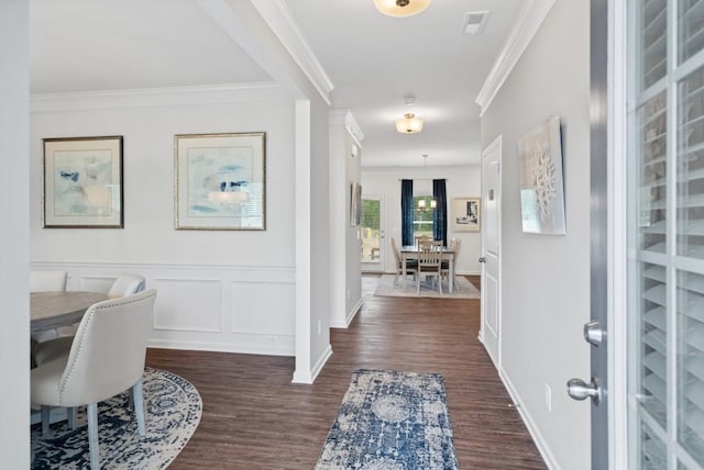 foyer with dark hardwood / wood-style floors and ornamental molding