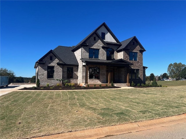 1026 Traditions Way, Jefferson, GA 30549 - view of front facade with board and batten siding, brick siding, and a front yard