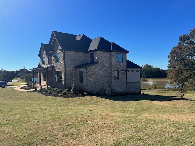 1026 Traditions Way, Jefferson, GA 30549 - view of home's exterior featuring a lawn, a water view, and brick siding