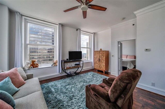 living area featuring ceiling fan and dark wood finished floors