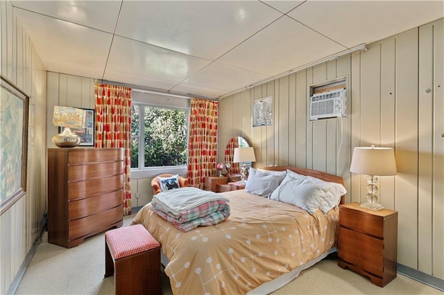 bedroom featuring an AC wall unit and light colored carpet