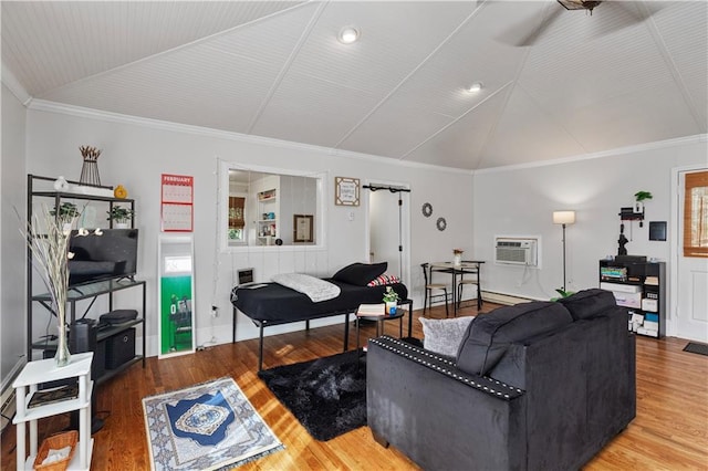 living room featuring lofted ceiling, crown molding, a wall unit AC, and wood finished floors