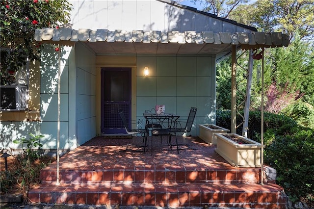 exterior space featuring outdoor dining area and a wooden deck