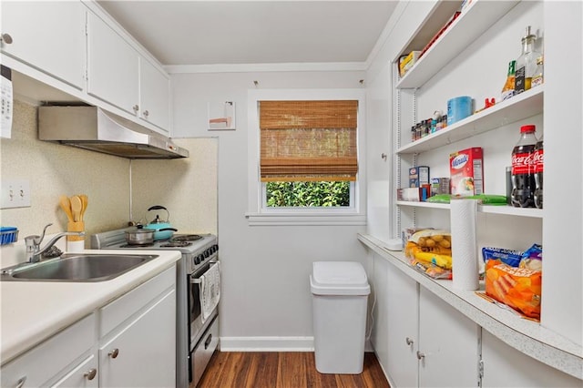 kitchen featuring stainless steel stove, under cabinet range hood, a sink, white cabinetry, and light countertops