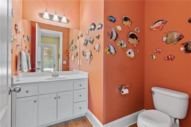 bathroom featuring vanity, toilet, and hardwood / wood-style floors