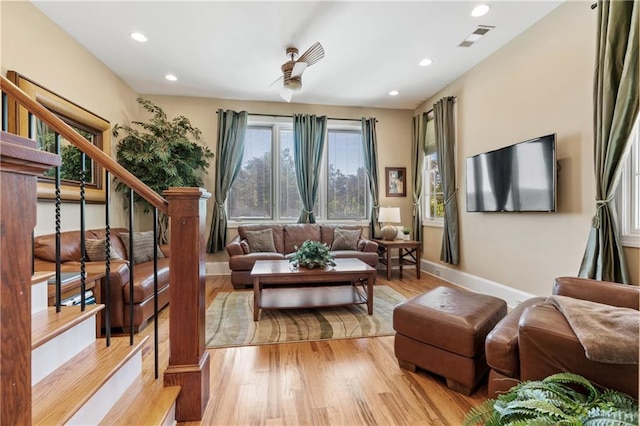 living room featuring ceiling fan and light wood-type flooring