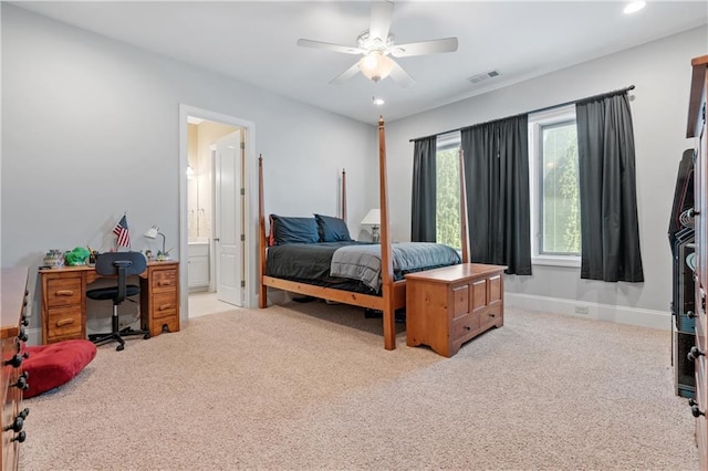 carpeted bedroom with connected bathroom and ceiling fan