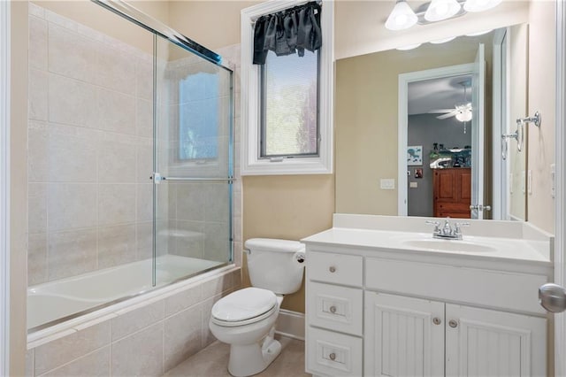 full bathroom featuring bath / shower combo with glass door, ceiling fan, vanity, and toilet