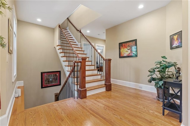 stairs featuring wood-type flooring