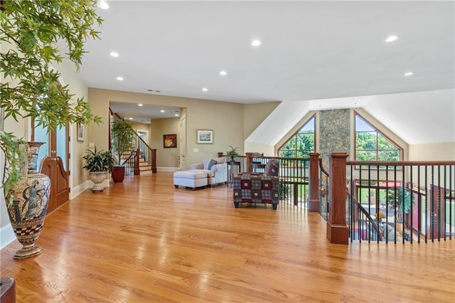 additional living space with lofted ceiling and light wood-type flooring