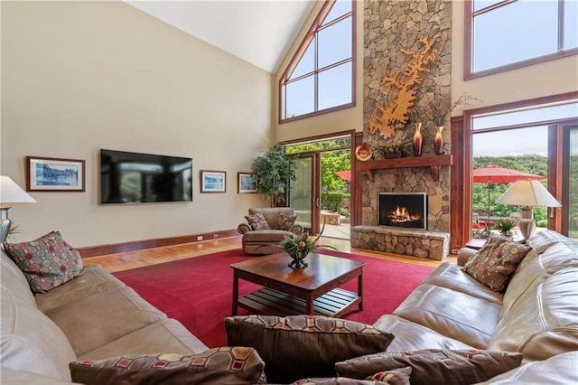 living room with wood-type flooring, a fireplace, and high vaulted ceiling