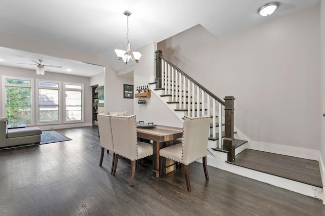 dining room featuring dark hardwood / wood-style flooring and ceiling fan with notable chandelier