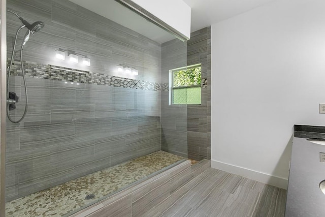 bathroom featuring vanity and tiled shower