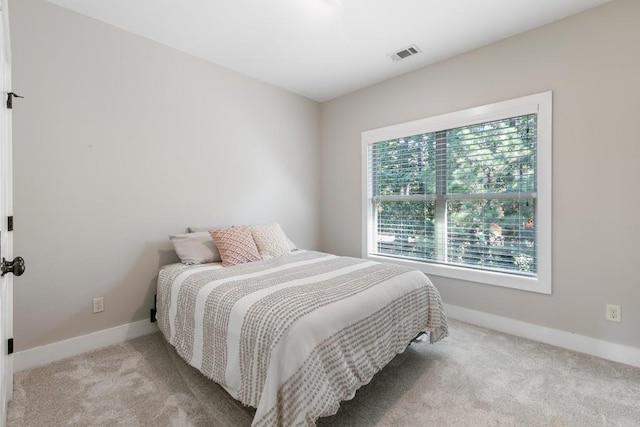 bedroom featuring light carpet