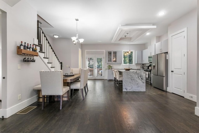 dining room featuring a chandelier, french doors, and dark wood-type flooring