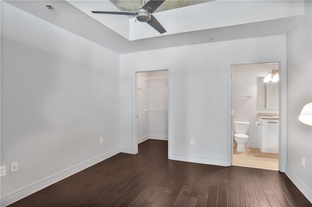 44 Peachtree Pl NE Unit 1929, Atlanta, GA 30309 - unfurnished bedroom with a walk in closet, wood finished floors, baseboards, a closet, and connected bathroom