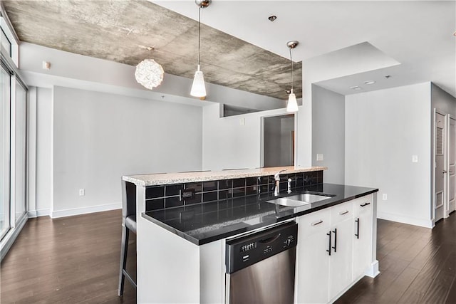44 Peachtree Pl NE Unit 1929, Atlanta, GA 30309 - kitchen with stainless steel dishwasher, a sink, baseboards, and dark wood-style flooring