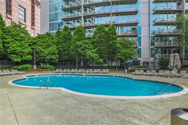 44 Peachtree Pl NE Unit 1929, Atlanta, GA 30309 - community pool featuring a patio and fence