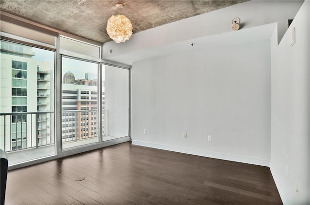 44 Peachtree Pl NE Unit 1929, Atlanta, GA 30309 - unfurnished room featuring wood finished floors, baseboards, a chandelier, and expansive windows