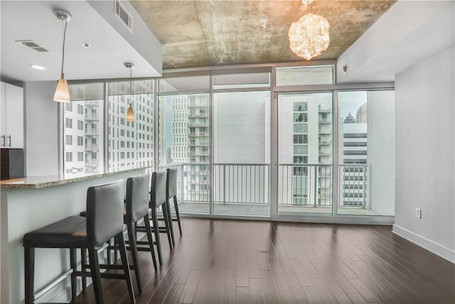 44 Peachtree Pl NE Unit 1929, Atlanta, GA 30309 - dining room featuring dark wood finished floors, baseboards, a chandelier, and floor to ceiling windows