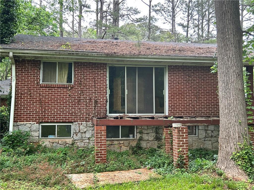 view of side of home featuring brick siding