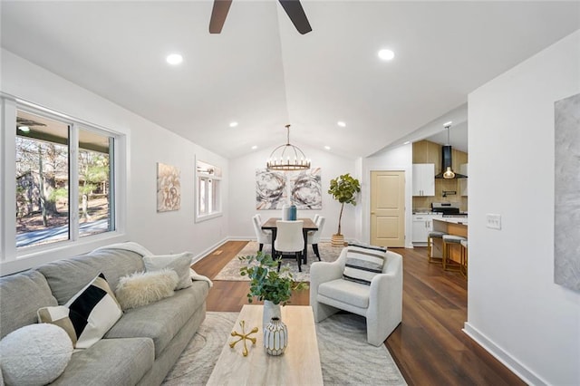 living room with dark hardwood / wood-style flooring, ceiling fan with notable chandelier, and lofted ceiling