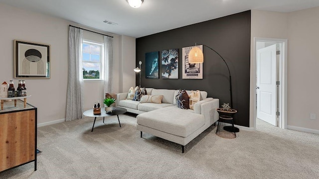 living room featuring baseboards, visible vents, and carpet