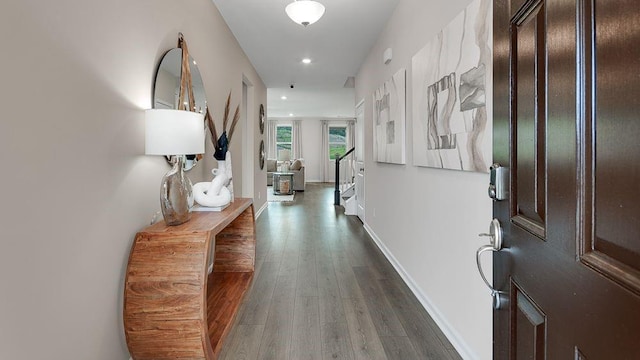 hall featuring dark wood-style floors, recessed lighting, and baseboards