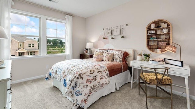 carpeted bedroom with visible vents and baseboards