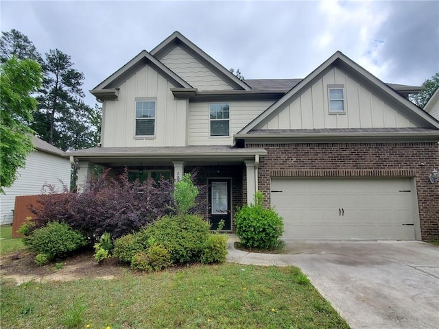 craftsman-style home featuring board and batten siding, concrete driveway, a garage, and brick siding