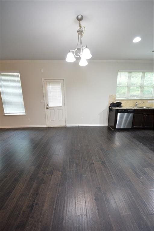 unfurnished dining area with ornamental molding, a chandelier, dark wood-style flooring, and baseboards