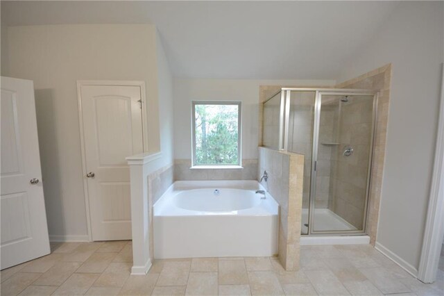 full bath with lofted ceiling, a stall shower, a bath, and baseboards