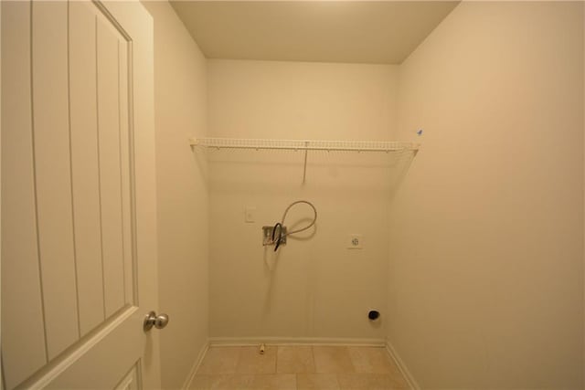 washroom with electric dryer hookup and baseboards