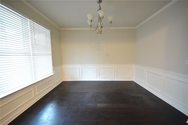 unfurnished room featuring a chandelier, crown molding, dark wood-style flooring, and wainscoting