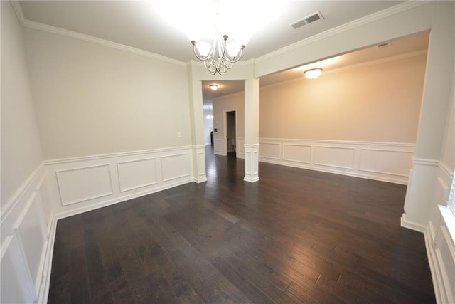 spare room featuring a decorative wall, a chandelier, dark wood-style flooring, wainscoting, and ornamental molding