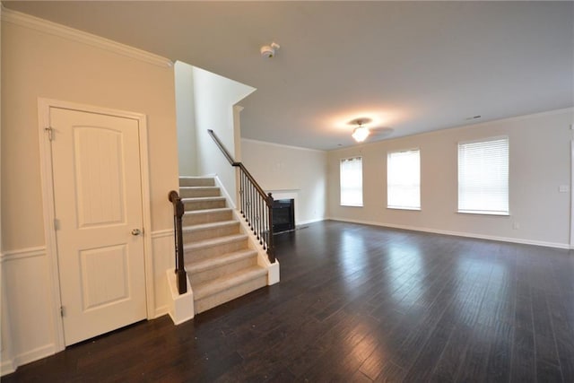 unfurnished living room with crown molding, stairway, hardwood / wood-style flooring, baseboards, and a fireplace