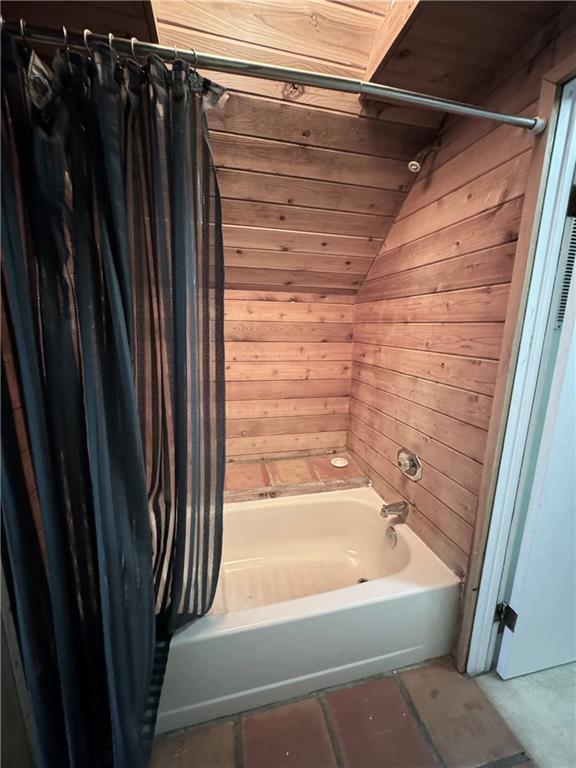 2606 Ramblewood Ct, Acworth, GA 30102 - bathroom featuring shower / bath combo, lofted ceiling, wood ceiling, and wooden walls