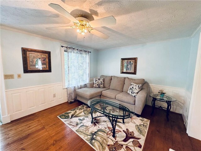 2606 Ramblewood Ct, Acworth, GA 30102 - living room featuring dark wood-type flooring, ceiling fan, crown molding, and a textured ceiling