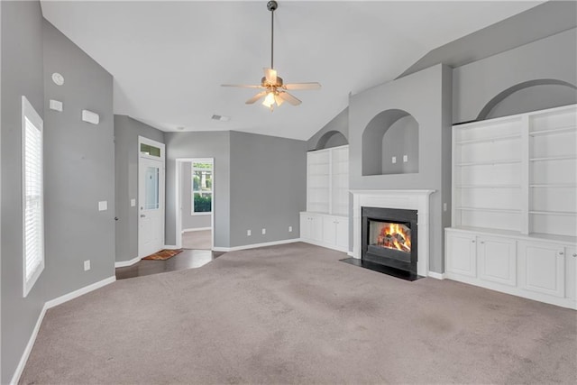 903 Duncan Ter, Canton, GA 30115 - unfurnished living room featuring carpet, vaulted ceiling, a ceiling fan, a fireplace with flush hearth, and built in shelves