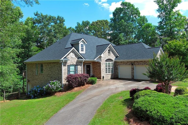 view of front of property with a front yard and a garage