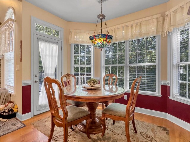 dining space featuring plenty of natural light and light hardwood / wood-style floors